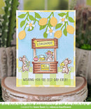 Card with lemonade stand illustration and lemons on a wooden surface