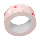 Roll of pink tape with heart patterns on a white background