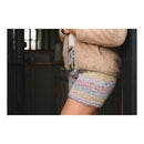 Person wearing a beige jacket and colorful striped Knitted Brunch shorts with a blurred background