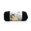 Black yarn skein with a label featuring a woman wearing a beige sweater on a white background