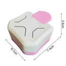 Small white and pink rectangular object with dimensions indicated on a white background