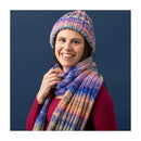 women wearing colourful knitted beanie and scarf in front of a blue background