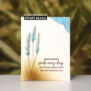 Penny Black card with floral design and motivational quote on a blurred natural background