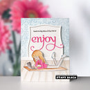 Card with a design of a person using a laptop and the word 'enjoy' on a decorative background.