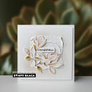 Card with floral design and 'Penny Black' branding on a blurred green background