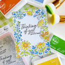 Card with floral design and 'Thinking of you with a grateful heart' text, surrounded by stamping supplies.