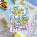 Card with lemon-themed illustration surrounded by stamping supplies on a light blue background