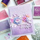 Handmade card with floral design and 'Beautiful' text, surrounded by craft supplies.
