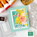 Handmade birthday card with floral design and decorative elements on a white surface.
