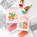 Card-making supplies including cards, stamps, and decorative elements on a white surface.