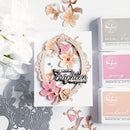 Decorative card with floral elements and 'just a note to brighten your day' text, surrounded by craft supplies on a white background.