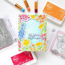 Colorful floral card with stamping tools on a white background