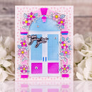 Greeting card with a blue door, pink flowers, and 'So glad you're here' text on a floral background.