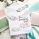 Card with floral stickers and text 'For a beautiful soul' on a white background with craft supplies.