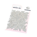 Floral press plate on a pink background with brand label