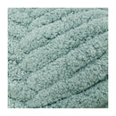 Close-up of a textured teal fabric on a white background