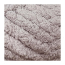 Close-up of a textured beige fabric with braided pattern