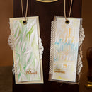 Two decorative bookmarks with intricate designs and text on a dark background