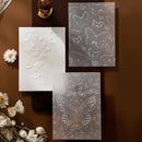Three embossed butterfly designs on textured paper with a brown background and white flowers.