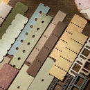 Set of colorful paper strips with perforated edges on a wooden surface