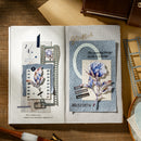 Open book with decorative pages featuring floral designs and text on a wooden surface.