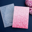 Two silicone molds with patterned designs on a dark blue background