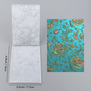 Two decorative paper sheets with floral patterns and measurements on a gray background