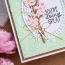 Card with floral design and 'You're doing great!' text on a textured green background