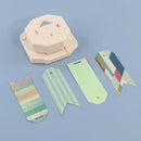 Hexagonal paper punch with cut-out shapes on a blue background