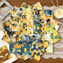 Set of bee-themed placemats on a wooden table with a candle and lace doily.