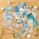 Collection of beach-themed paper sheets with shells and sand on a sandy background