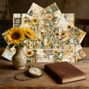 Decorative collage with sunflowers, vintage book, and pocket watch on a wooden surface.