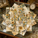 Collection of decorative paper with sunflower designs on a glass surface.