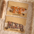 Decorative paper with floral letter 'TUP' and animal-themed letter 'KID' on a textured fabric background.