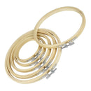 Set of wooden embroidery hoops with metal clamps on a white background