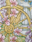 Cross-stitched design with a wheel and flowers