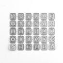 Metallic letter stamps on a white background