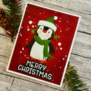 Christmas card with a penguin design on a red background, surrounded by pine branches.