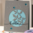 Handmade card with 'hello' and leaf design on gray background
