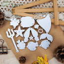Set of white metal cutting dies on a textured surface with decorative elements.