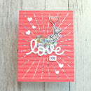 Card with 'love you' text and cartoon bear on a pink background