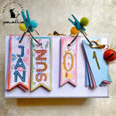 Colorful paper bookmarks with decorative text and clothespins on a textured surface.