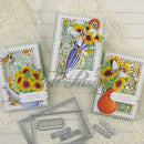Three decorative cards with sunflower designs and metal dies on a textured surface.