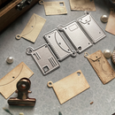 Metal die cutters and leather pieces on a gray surface