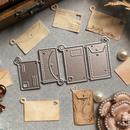 Metal die cutters and embossers on a gray surface with leather tags.