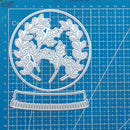 Metal die cutters with leaf design on a blue cutting mat