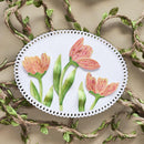 Decorative plate with pink tulips on a textured background