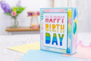 Colorful birthday card with 'Happy Birthday' text on a blurred background