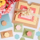 Colorful paper envelopes and a gift card with a bow on a white background