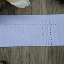 Sheet of pre-printed letters and symbols on a wooden surface
